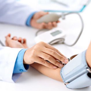 A doctor checking the blood pressure of another person.