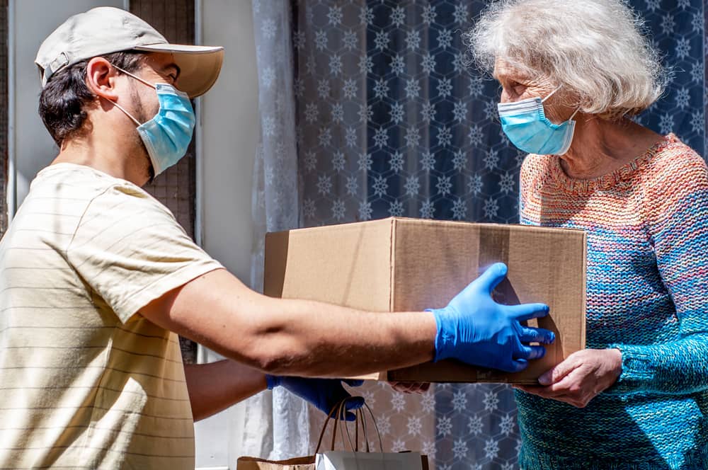 A man in blue gloves and a woman wearing masks.